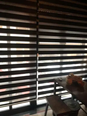 a room with a table and a window with blinds at The Black key in Athens