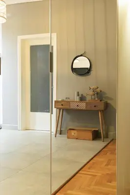 a glass door in a room with a table at Aiolos Elegant retro suite in GLYFADA centre in Athens