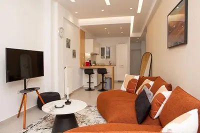 a living room with a couch and a tv at M23 by SpitiSou in Athens