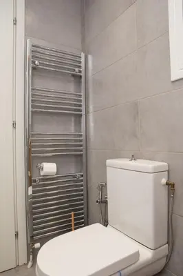 a bathroom with a white toilet in a room at M23 by SpitiSou in Athens