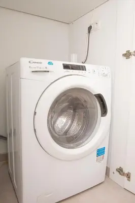 a white washing machine in a room at M23 by SpitiSou in Athens