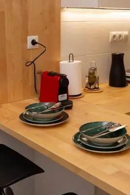a kitchen counter with plates and a toaster on it at M23 by SpitiSou in Athens