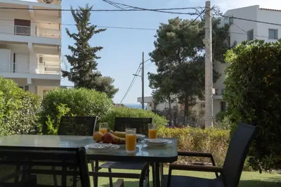 a table with fruit and orange juice on it at Palm & Pearl Apartment in Athens