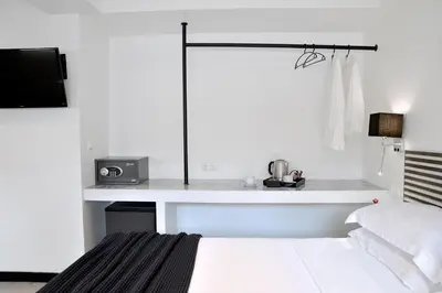 a bedroom with a bed and a desk with a tv at Alter Athens in Athens
