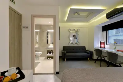 a living room with a couch and a bathroom at Alter Athens in Athens