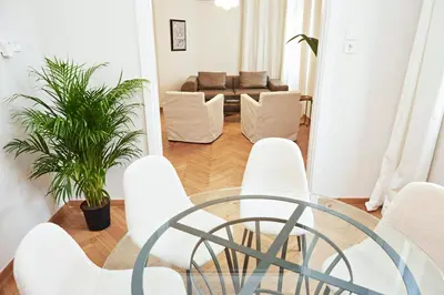 a glass table and chairs in a living room at Perikleous Apartment in Athens