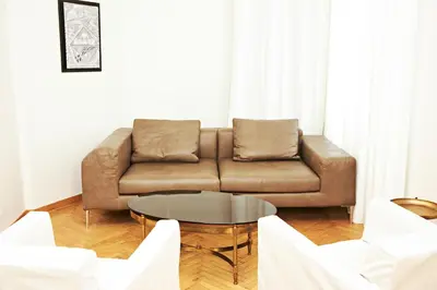 a living room with a couch and a table at Perikleous Apartment in Athens