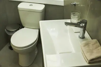 a bathroom with a white toilet and a sink at Perikleous Apartment in Athens