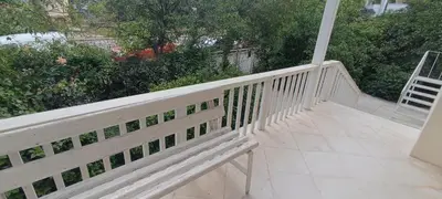 a white railing on a porch with a bench at Dafni's Super Home in Athens