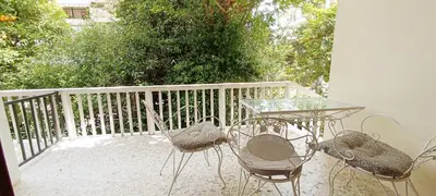 a patio with a table and chairs on a balcony at Dafni's Super Home in Athens