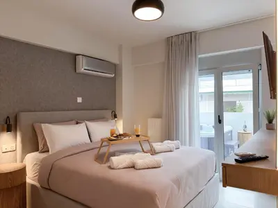 a bedroom with a large bed with a table on it at Airrent Apartments 1 The Athens Jacuzzi Lounge in Athens