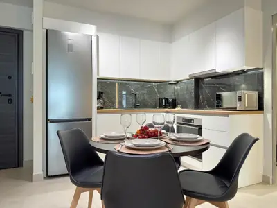 a kitchen with a table with chairs and wine glasses at Airrent Apartments 1 The Athens Jacuzzi Lounge in Athens