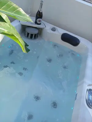 a bathtub filled with water with a bottle in it at Airrent Apartments 1 The Athens Jacuzzi Lounge in Athens