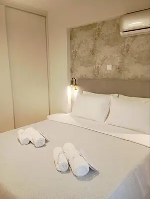 a bed with two towels on top of it at Airrent Apartments 1 The Athens Jacuzzi Lounge in Athens