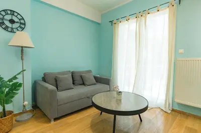 a living room with a couch and a table at Ma de Bright Stay Attiki Metro in Athens