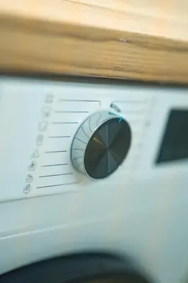 a close up of a washing machine with a dial at Ma de Bright Stay Attiki Metro in Athens