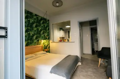 a bedroom with a large bed in a room at The Athens Green Apt in Athens