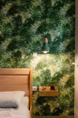 a bedroom with a green leafy wall mural at The Athens Green Apt in Athens