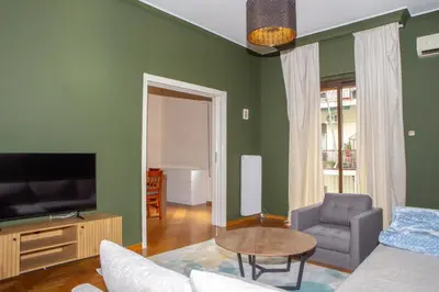 a living room with a couch and a tv at P23 by SpitiSou in Athens