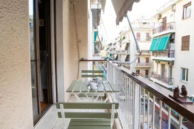 a balcony of a building with two benches at P23 by SpitiSou in Athens
