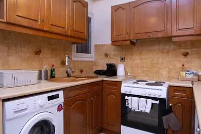 a kitchen with a stove and a washing machine at P23 by SpitiSou in Athens