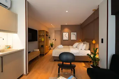 a hotel room with a bed and a kitchen at Psiri 38 Boutique Balcony Suite in Athens