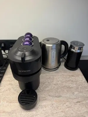 a coffee maker and two cups on a counter at Psiri 38 Boutique Balcony Suite in Athens