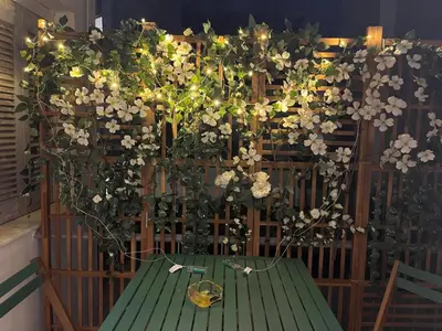 a green table with flowers on a fence at Psiri 38 Boutique Balcony Suite in Athens