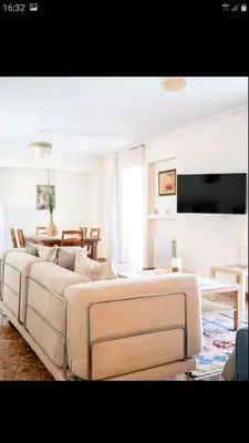 a living room with a couch and a table at Beautiful Victoria in Athens