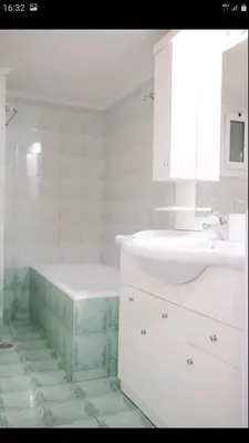 a bathroom with a sink and a bath tub and a sink at Beautiful Victoria in Athens