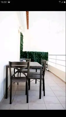 a table and chairs sitting on a balcony at Beautiful Victoria in Athens