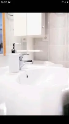 a bathroom sink with a roll of toilet paper on it at Beautiful Victoria in Athens