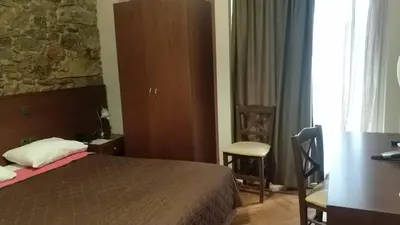 a bedroom with a bed and a desk and a table at Ambrosia Suites in Athens