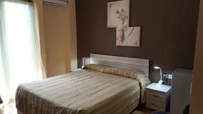 a bedroom with a bed and a window at Ambrosia Suites in Athens