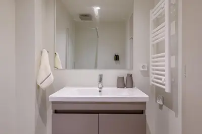 a white bathroom with a sink and a mirror at Acropolis Dream with Plunge Pool in Athens