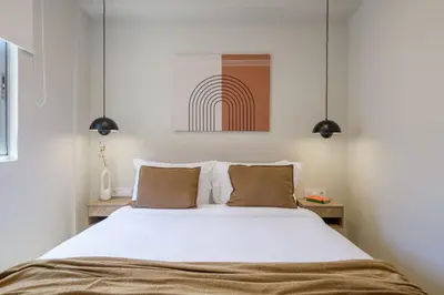 a bedroom with a large white bed with two pillows at Acropolis Dream with Plunge Pool in Athens