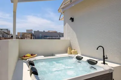 a hot tub on the balcony of a building at Acropolis Dream with Plunge Pool in Athens