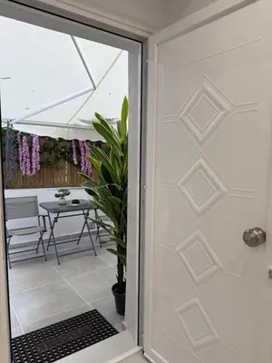 a door leading to a patio with a table at Stylish Athens Base near Acropolis & Metro in Athens