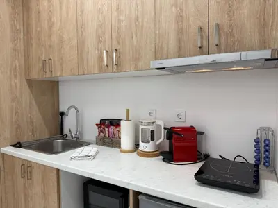 a kitchen with a sink and a counter top with a counter top at Stylish Athens Base near Acropolis & Metro in Athens