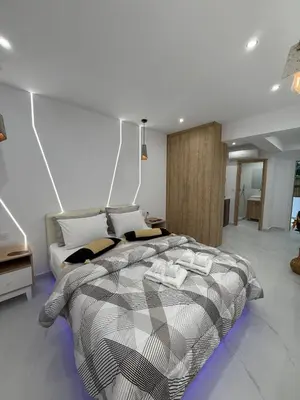 a bedroom with a bed with a black and white comforter at Stylish Athens Base near Acropolis & Metro in Athens