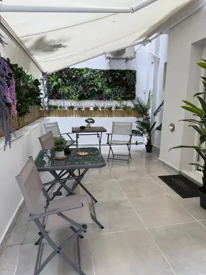a patio with a table and chairs and plants at Stylish Athens Base near Acropolis & Metro in Athens