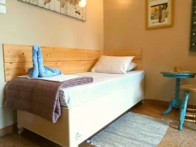a bedroom with a bed with a blue towel on it at Froso's fresh old apartment in Gazi in Athens