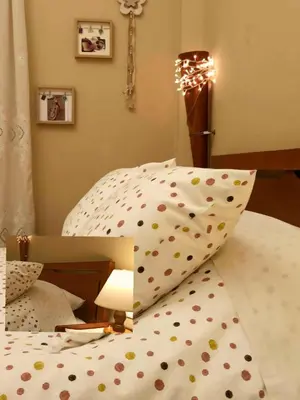 a bedroom with a bed with polka dot pillows at Froso's fresh old apartment in Gazi in Athens