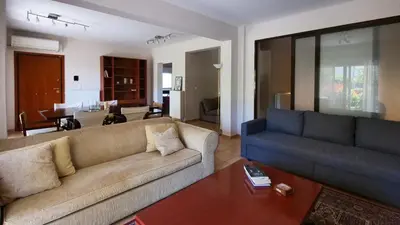 a living room with two couches and a table at Michael Apartment, near the Airport in Koropíon