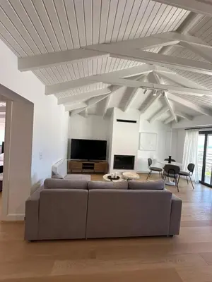 a large living room with a couch and a table at Penthouse with sea view in Athens