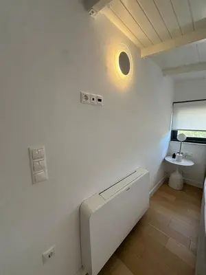 a white room with a mirror and a sink at Penthouse with sea view in Athens