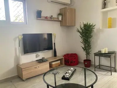 a living room with a flat screen tv on the wall at Roof Garden Home in Athens