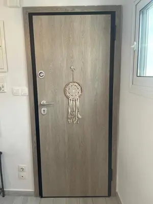 a wooden door with a dream catcher on it at Roof Garden Home in Athens