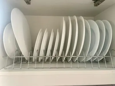 a row of white plates on a shelf at Roof Garden Home in Athens