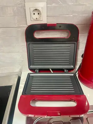 a red and black toaster sitting on top of a counter at Roof Garden Home in Athens